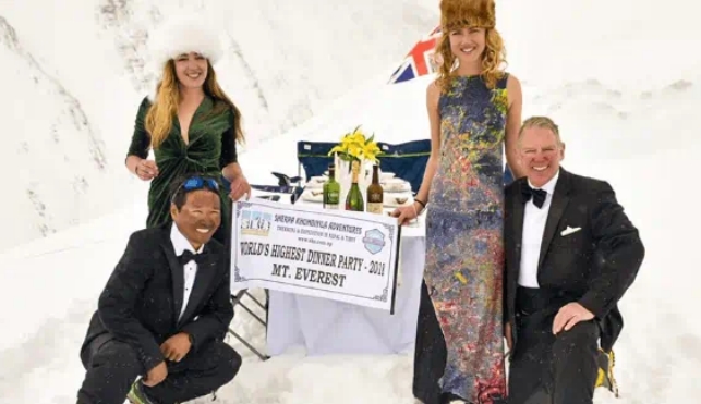 Group of people having a dinner party on Everest